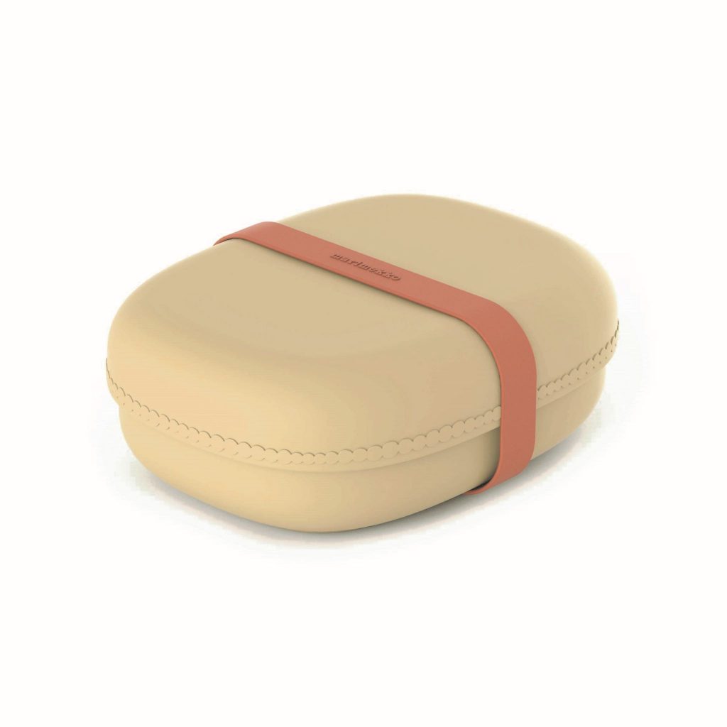 Beige lunch box with a leather strap in the middle.