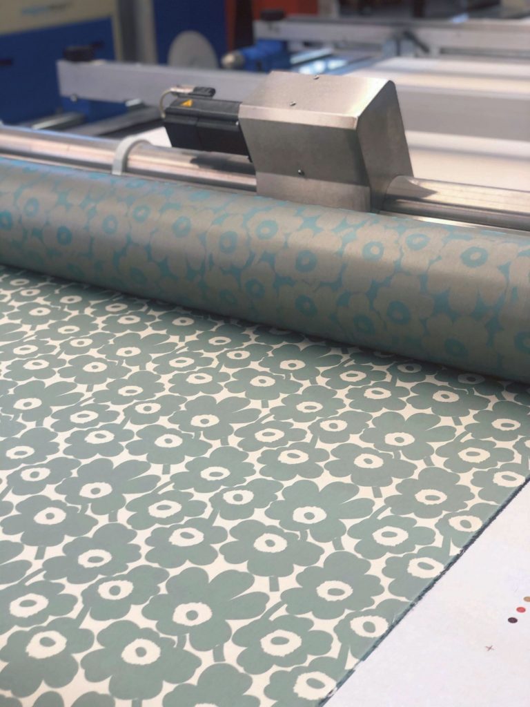 A green Unikko fabric on the table.