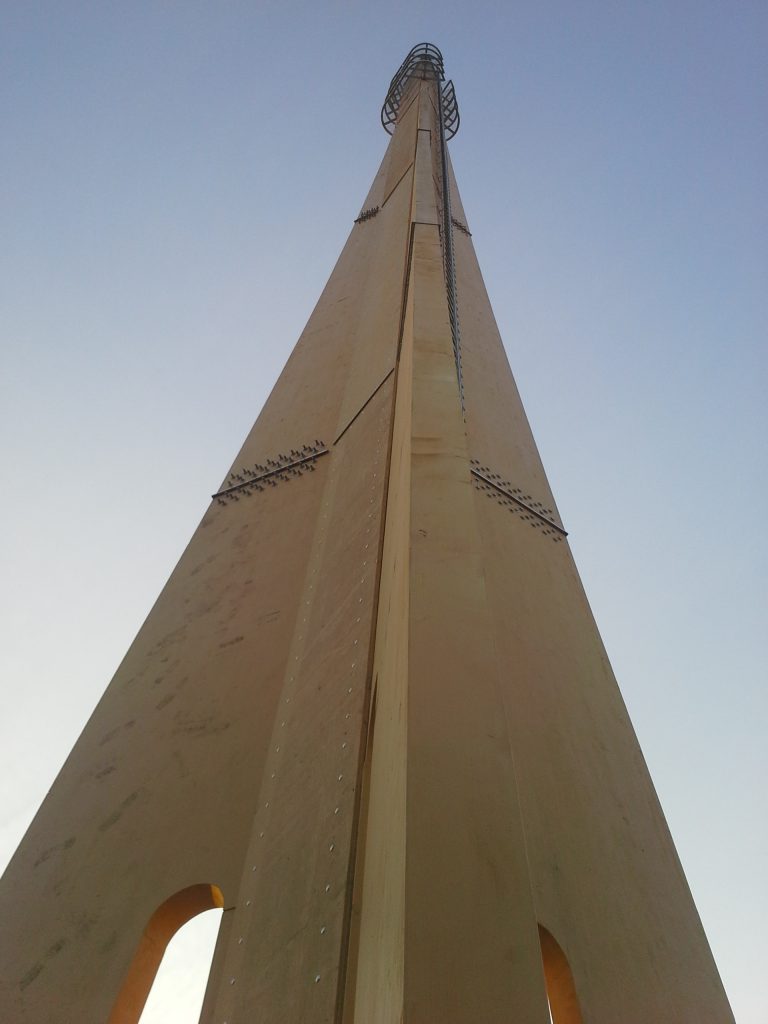 A wooden telecommunication mast.