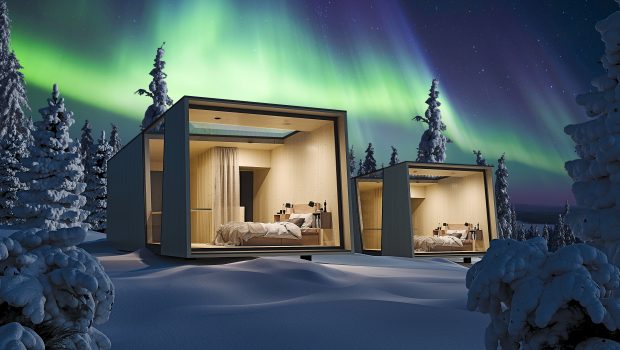 Accommodation in winter forest with northern lights in the background.