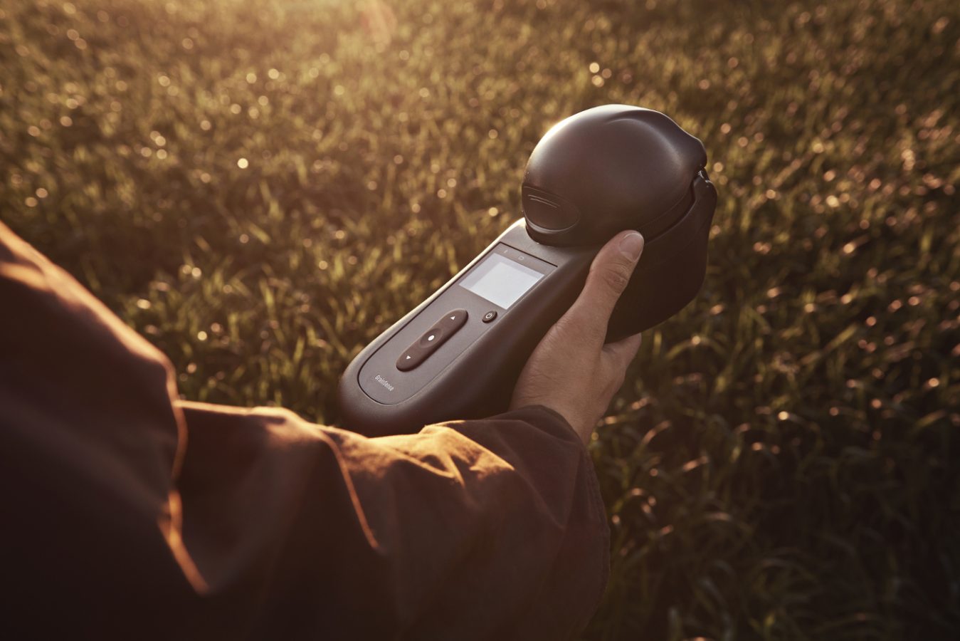 GrainSense in hand, in the background field.